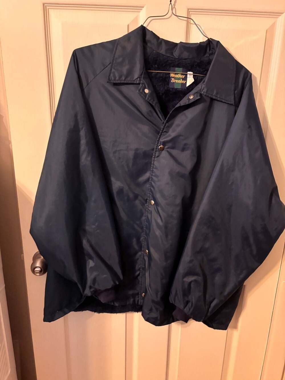 Weather Breaker Vintage Navy Faux Fur Nylon Jacket has a few white spots on slee